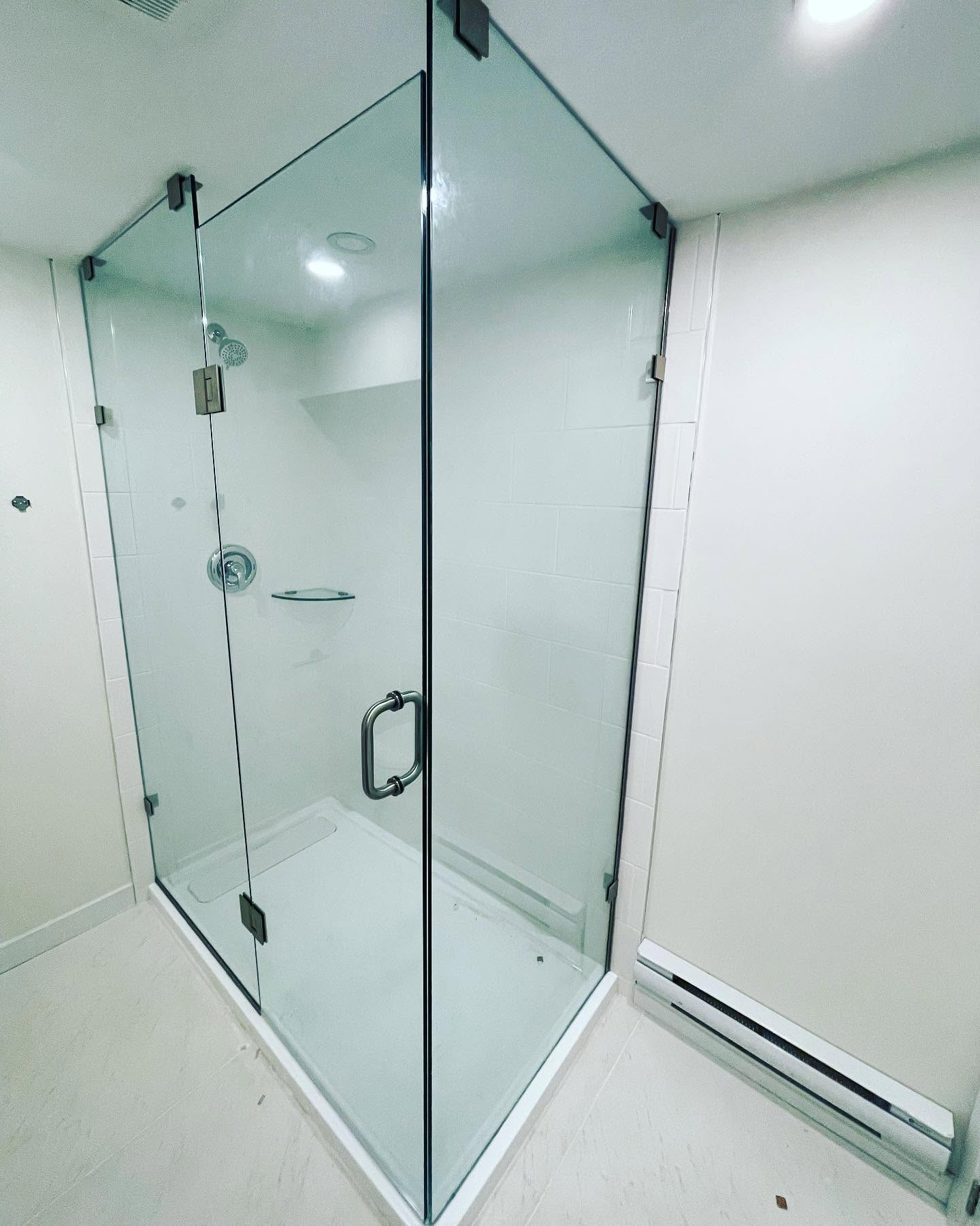 Frameless clear glass corner shower enclosure